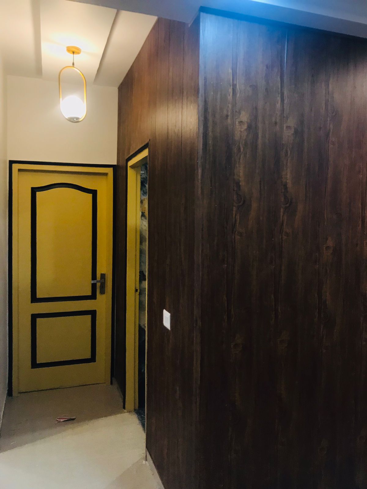 Wooden wall cladding and yellow door detail